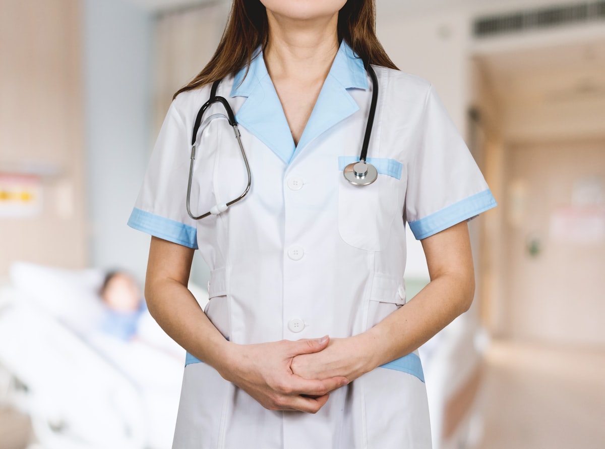 Medical professional in white coat with stethoscope on a hospital ward