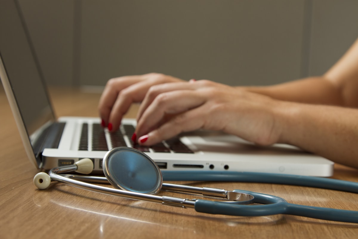Physician's desk with laptop and stethoscope